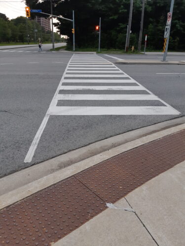 a road crossing nudge with white strips